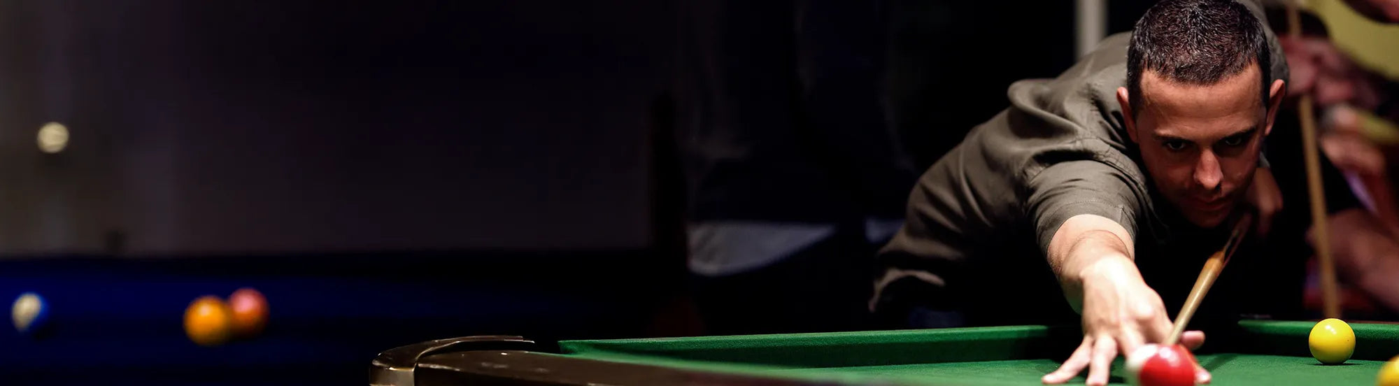 Man lining up a shot in the corner pocket